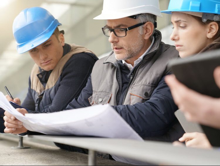 Instructor discussing with young engineers