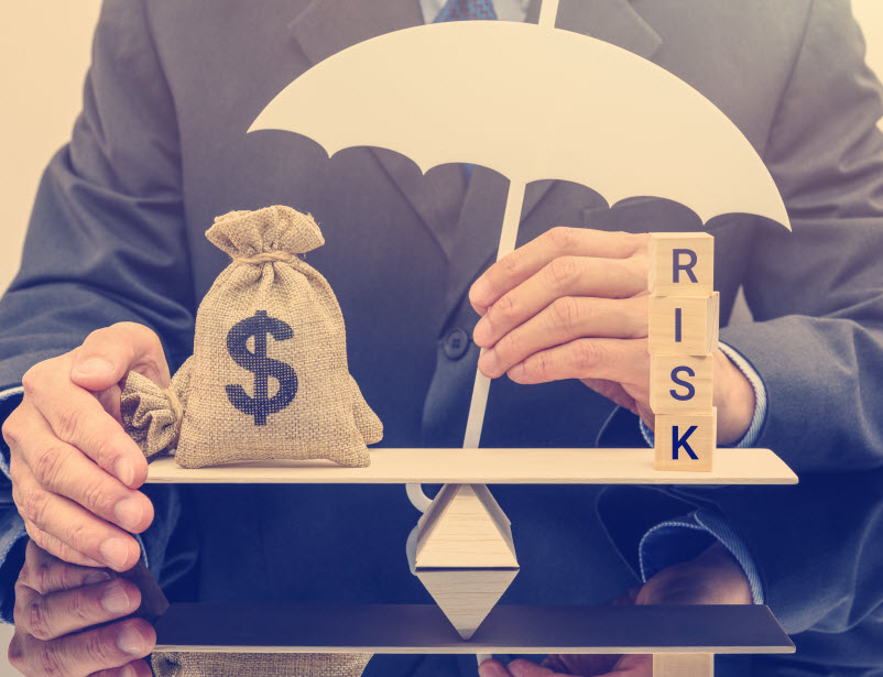 Businessman holds a white umbrella, protects a dollar bag on basic balance scale