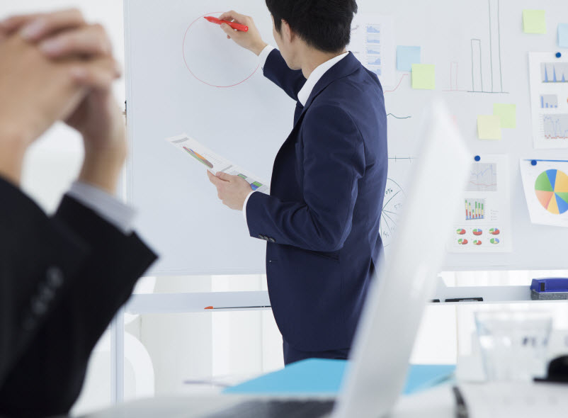 Businessman discussing the financial report on a whiteboard